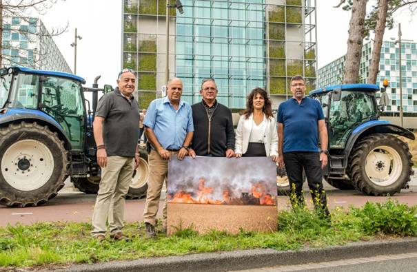 Shurat Hadin President Nitsana Darshan-Leitner with farmers from the Gaza border communities whose fields were damaged by incendiary balloons, protesting at the ICC at the Hague. (photo credit: SHURAT HADIN)